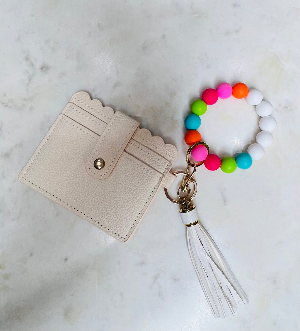 Always on the go? The Popsicle O Wristband Keychain has got you covered! Made with 15-mm silicone beads, a split ring, clasp, and leather tassel, it's the perfect companion for life on-the-move. Plus, it comes with a super convenient credit card and ID holder, complete with a key ring to quickly hook up your keys. Whip it around your wrist and zoom out the door - no hassle, no fuss!
